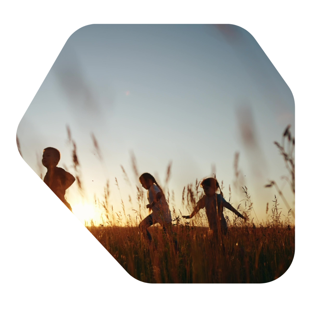 Children running in a field at sunset for a description of Child Dependant Visa Solicitors UK OTB Legal