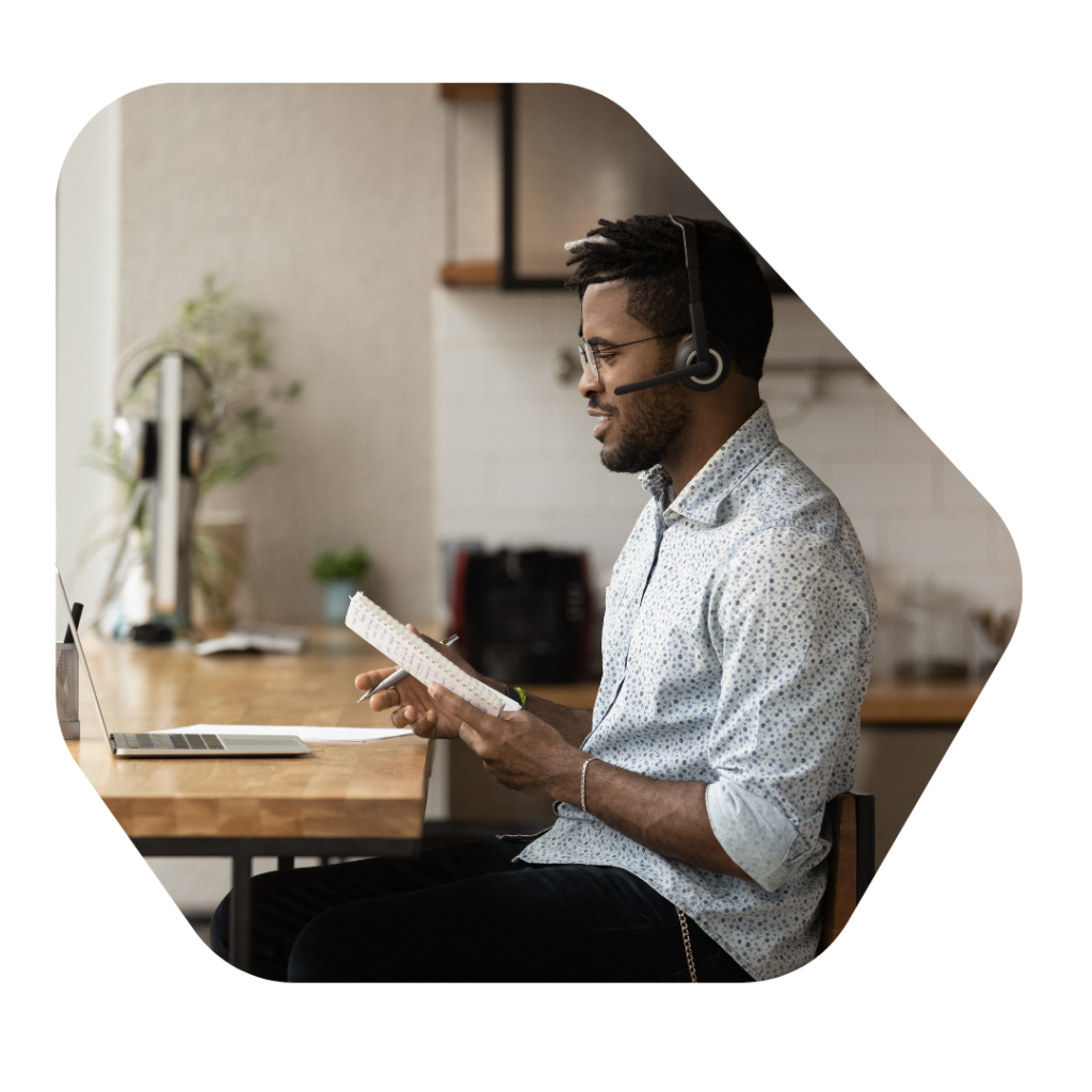 man with headset at desk. Expansion Worker Visa UK Lawyers