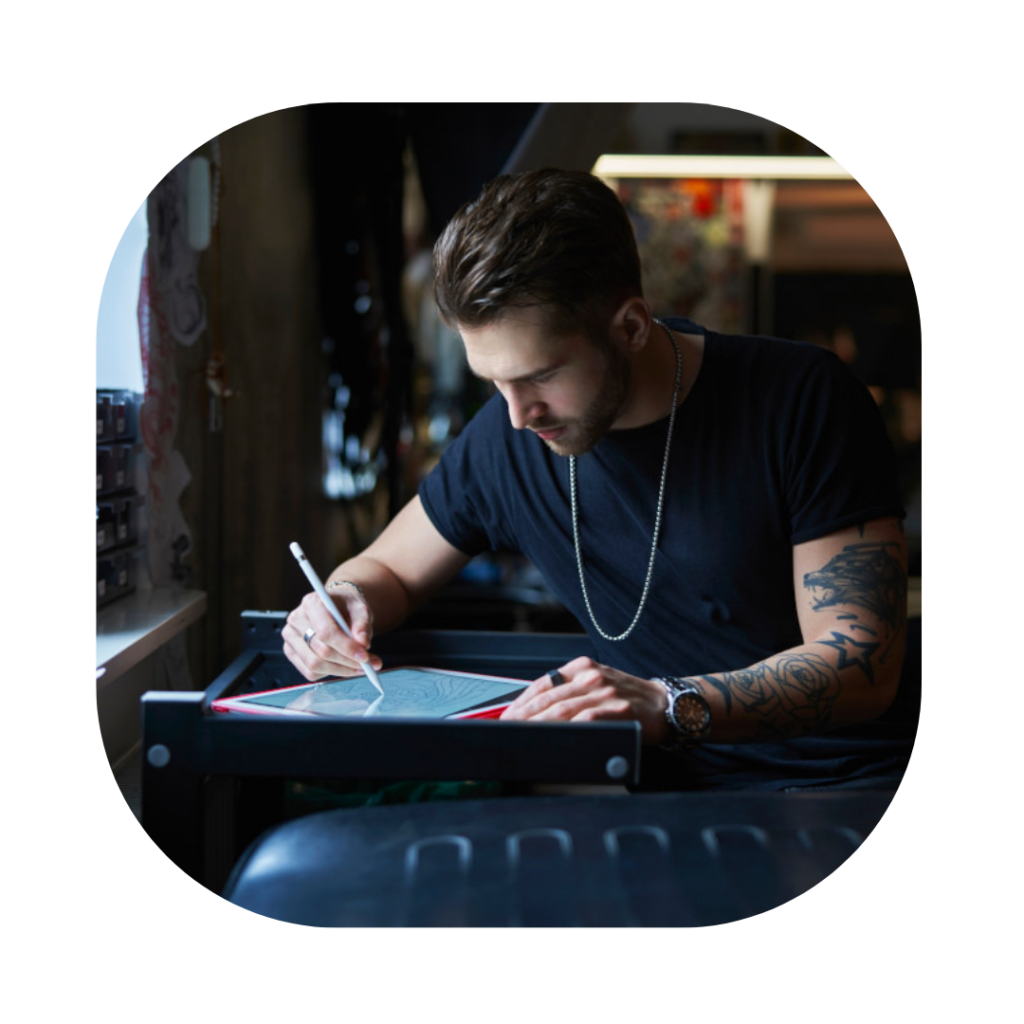 Man at desk creating art for Global Talent Visa Solicitor