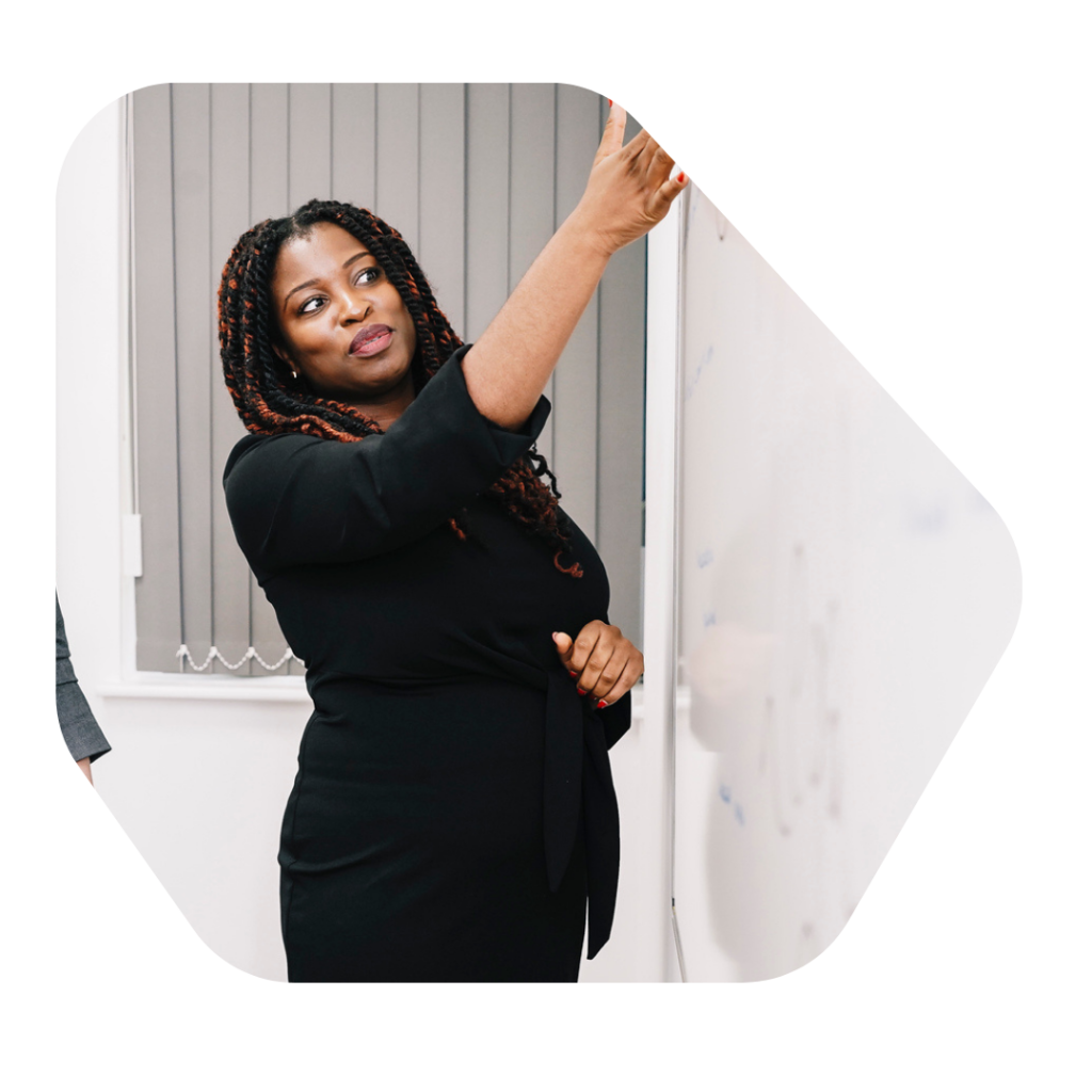 Female Solicitor pointing at a whiteboard. Adult Dependent Relatives Visa UK Approved